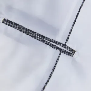 Close-up view of men's suit jacket pocket piping, exquisite grid trim detail, fine stitching.