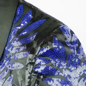 Close-up detail of mens sequin blazer shoulder, blue and black floral embroidery pattern.
