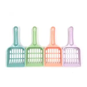 Plastic cat litter scoop detail showing grid design and pastel colors for pet cleaning.