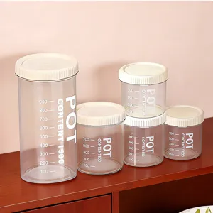 Clear plastic food storage jars with lids and scale marks for kitchen grain pantry.