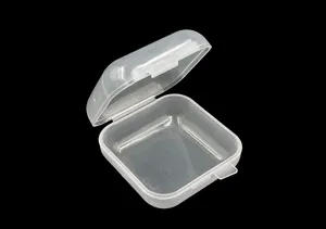 Close up of clear plastic storage box, mini flip-top design for small jewelry and parts.