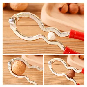 Multi-functional metal nutcracker with red plastic handle for easy peeling of walnuts and nuts.