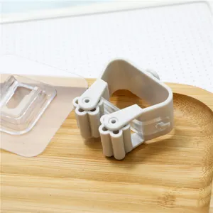 Traceless mop and broom holder wall mounted punch free clip for bathroom organization.