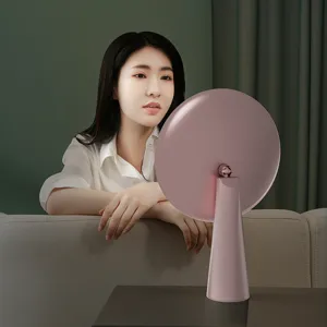 Pink LED desktop makeup mirror with round light-up mirror surface and elegant stand.