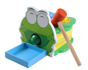 Wooden toy detail showing the cute green frog pounding bench with hammer and ball receiver box.