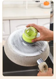 Kitchen liquid dispensing pot brush with steel wire head cleaning frying pan bottom easily.