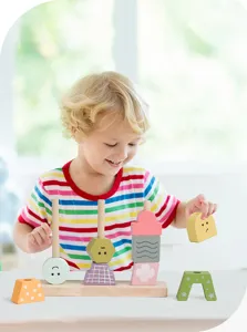 Detailed scene showing a toddler playing with colorful wooden educational shape sorting stacking puzzle blocks.