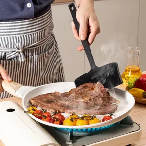 Main image of a silicone spatula cooking steak in a pan, heat-resistant kitchen turner tool.