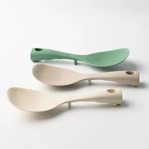 Set of 3 vertical non-stick rice paddles with standing base and textured dots for kitchen use.