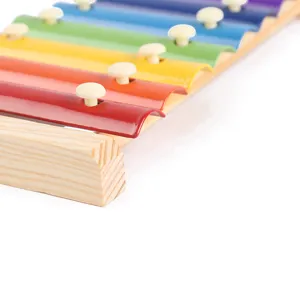 Children wooden xylophone musical toy detail close up of colorful metal bars and frame.