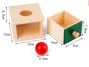Close-up detail of Montessori wooden toy coin box and drawer with red ball, early education.