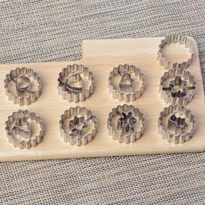 Stainless steel cookie cutter set detail view, showing nested shapes and fluted edges clearly.