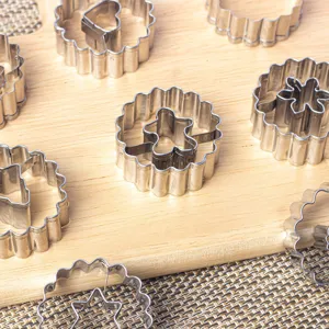 Stainless steel cookie cutter set with wave edges and geometric shapes for baking pastry use.