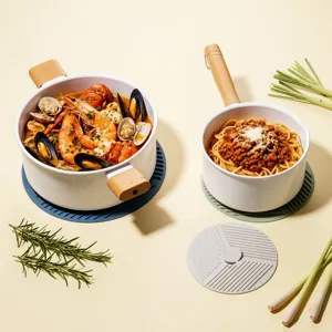 White ceramic pot set with wooden handles and silicone insulation mats for kitchen cooking.