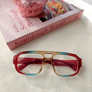 Primer plano detallado de una elegante montura de gafas con doble puente degradado en mesa.
