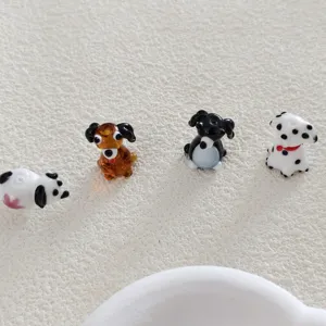 Close-up of cute glass dog beads, handmade DIY accessories, lovely charms for bracelets and earrings.