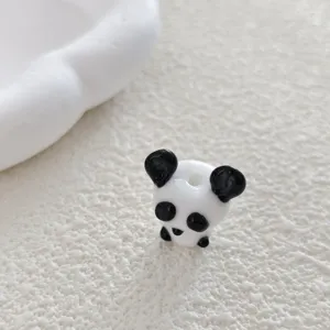 Close-up detail of cute 3D panda glass bead for DIY handmade bracelets and earrings crafting.