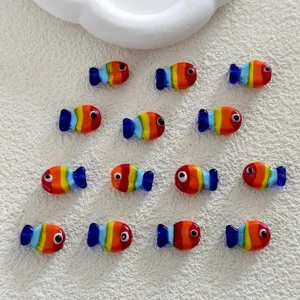 Close-up detail of colorful glass fish beads, perfect for DIY handmade jewelry and accessories.