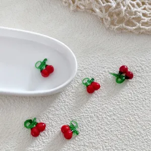 Close-up of red green cherry glass beads, cute DIY jewelry making accessories for earrings.