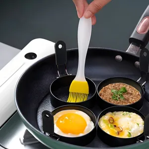 Non-stick egg ring mold set with silicone oil brush for frying eggs in pan detail view.