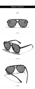 Vue détaillée de lunettes de soleil noires tendance avec double pont et barre métal.