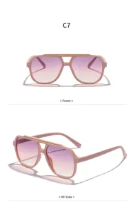 Lunettes de soleil rose dégradé élégantes avec barre dorée chic pour un style unique.