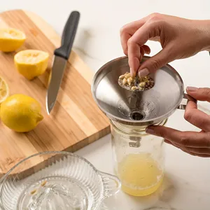 Stainless steel kitchen funnel with detachable strainer filter for liquid oil and fruit juice.
