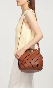 Retro brown woven leather crossbody bag featuring a chic triangular cutout handle for women.