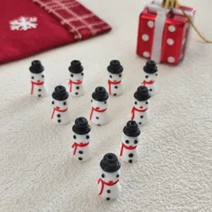 Christmas glass snowman beads for DIY jewelry making, cute holiday accessories detail shot.