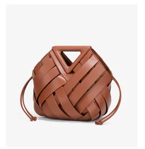 Brown woven leather handbag with unique triangular handle and stylish drawstring design.