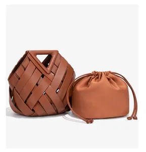 Brown woven leather handbag with distinctive rigid triangular handle and inner pouch.