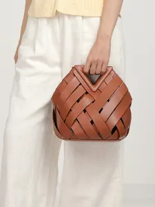 Women brown woven leather handbag with unique triangular cutout handle and stylish design.