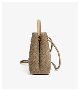 Woven leather bucket bag side detail, stylish beige shoulder crossbody bag for women.