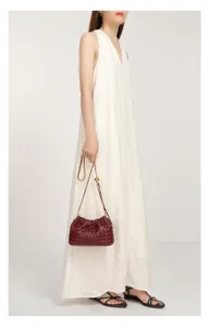 Woven leather chain shoulder bag for women, stylish pleated clutch purse with strap.
