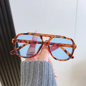 Lunettes de soleil rétro écaille de tortue à double pont avec verres bleu clair.