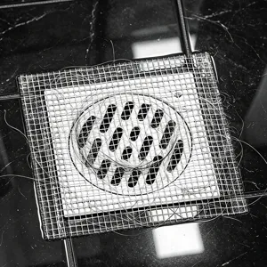 Disposable shower drain hair catcher mesh sticker anti-clogging filter for bathroom floor.