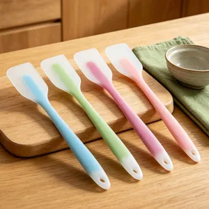 Silicone spatula detail view, four colorful baking tools neatly arranged on a wooden board.