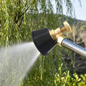 Agricultural high-pressure spray gun nozzle detail, brass adjustable valve, fine mist spray.