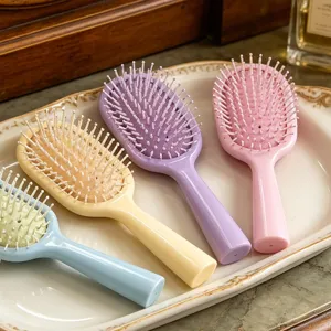 Detail shot of cute macaron color air cushion massage hair brush for daily portable use.
