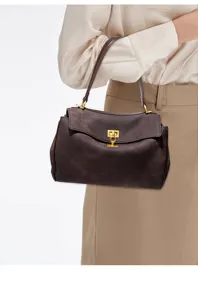 Brown suede shoulder handbag, premium minimalist design with elegant metal lock detail.