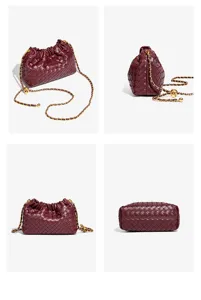 Detailed view of the burgundy woven leather shoulder bag, featuring a chic gold chain and knot accent.