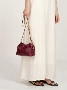 Chic women's woven leather shoulder bag with stylish chain strap and elegant pleated cloud design.