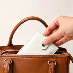Detail view of a sleek white PU leather card holder inside a brown bag scene for usage.