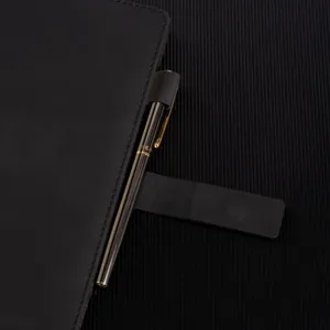 Black PU leather A5 business notebook detail shot featuring a sleek pen holder and metal pen.