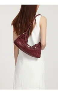 Detailed view of a stylish maroon woven leather shoulder hobo bag, perfect daily accessory.