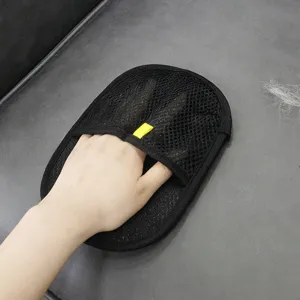 Close-up detail of black mesh pet hair removal glove showing textured surface for cleaning.