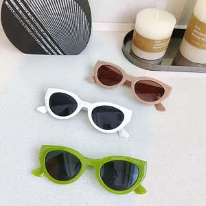 Detailed view of trendy cat-eye oval sunglasses in white, brown and green colors for daily wear.