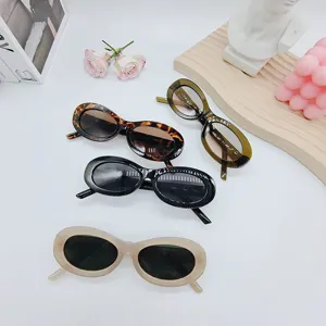 Detail view of stylish vintage oval sunglasses in multi colors, perfect for summer fashion wear.