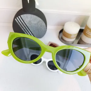 Detailed close-up view of trendy green small-frame round sunglasses, stylish outdoor eyewear.