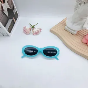 Detail view of trendy light blue oval sunglasses, stylish streetwear eyewear for sunny days.